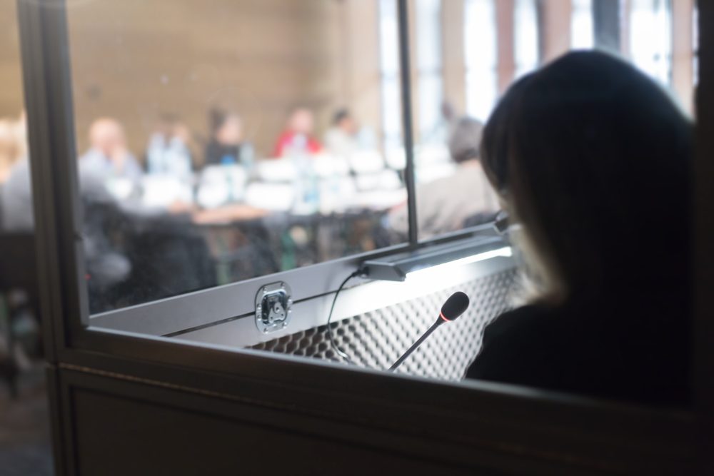 Interpreter working in a simultaneous interpretation booth