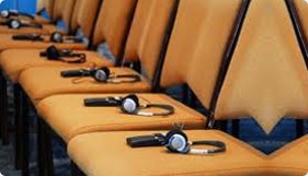 Interpretation headsets waiting on conference chairs